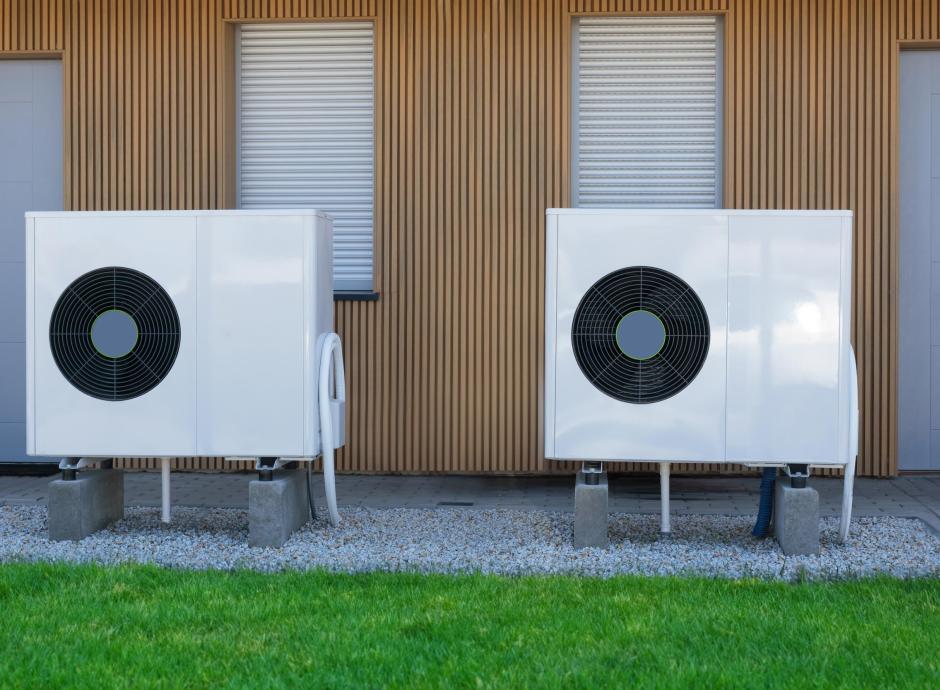 Two eco-friendly air-source heat pumps in front of a modern North Devon house.
