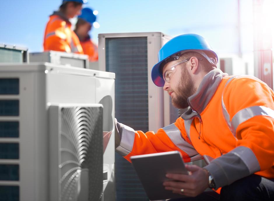 Air conditioning control technician installing HVAC Unit