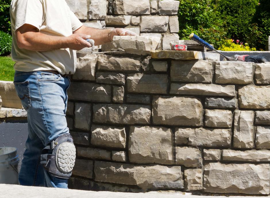 Stone mason building wall