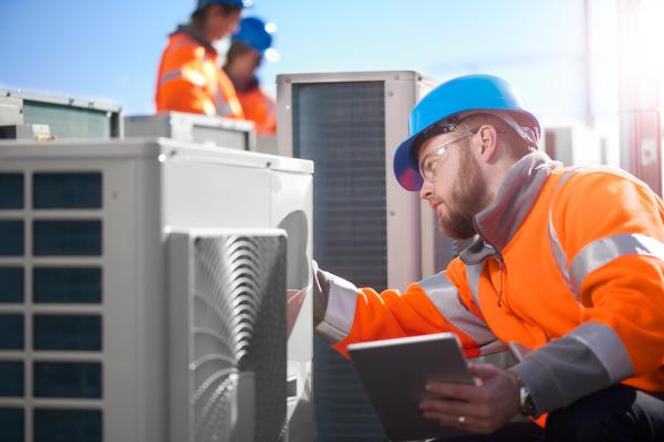 Air conditioning control technician installing HVAC Unit